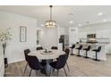 Open-concept layout featuring a dining area adjacent to a modern kitchen with stainless steel appliances at 11008 N 165Th Ave, Surprise, AZ 85388