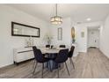 Bright dining room with modern lighting, stylish decor, and wood-look flooring at 11008 N 165Th Ave, Surprise, AZ 85388