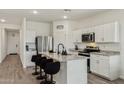 Well-lit kitchen featuring granite countertops, stainless steel appliances, and a breakfast bar at 11008 N 165Th Ave, Surprise, AZ 85388