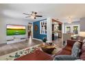 Open-concept living space featuring hardwood floors, modern lighting, and a mounted television at 1106 W Glenrosa Ave, Phoenix, AZ 85013