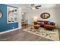Cozy living room with a decorative rug, stylish furniture, and a view into the dining area at 1106 W Glenrosa Ave, Phoenix, AZ 85013