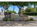Street view of the Woodlea Melrose neighborhood entrance sign under a canopy of trees at 1106 W Glenrosa Ave, Phoenix, AZ 85013