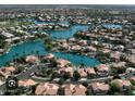 Breathtaking aerial view of a community nestled around a serene lake system at 1114 W Windjammer Dr, Gilbert, AZ 85233