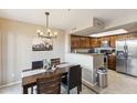 Inviting dining area adjacent to a kitchen with dark cabinets and stainless steel appliances at 1114 W Windjammer Dr, Gilbert, AZ 85233