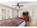 Bedroom boasting wood-look floors, ceiling fan, and access to the outdoor patio at 1217 N Miller Rd # 32, Scottsdale, AZ 85257