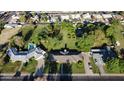 Expansive property with mature trees, a swimming pool, and a charming single-story home outlined with a yellow property line at 125 N Fraser E Dr, Mesa, AZ 85203