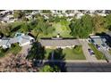 Spacious yard with mature trees and shrubs surrounding a well maintained single story home featuring a long roofline at 125 N Fraser E Dr, Mesa, AZ 85203