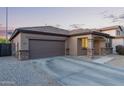 Beautiful single-story home with a two-car garage and well-kept landscaping at 14556 W Shaw Butte Dr, Surprise, AZ 85379