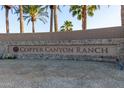 Stone sign for Copper Canyon Ranch surrounded by lush landscaping at 14556 W Shaw Butte Dr, Surprise, AZ 85379