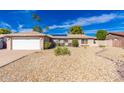 Charming single-story home with a two-car garage, solar panels, desert landscaping, and a well-maintained exterior at 15212 N 53Rd St, Scottsdale, AZ 85254