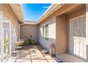 Inviting front porch with a seating area, decorative lantern, and shade, a relaxing welcome to your home at 15212 N 53Rd St, Scottsdale, AZ 85254