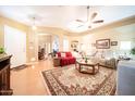 Bright, open living room with hardwood floors, a ceiling fan, and comfortable furniture at 17225 N 51St Dr, Glendale, AZ 85308