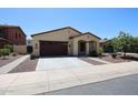 Inviting one-story home with a two-car garage, desert landscaping, and manicured curb appeal at 17947 W Jojoba Rd, Goodyear, AZ 85338