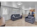 Cozy living room featuring a plush sofa, modern lighting, and easy access to dining at 1815 E Illini St, Phoenix, AZ 85040