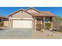 Charming single-story home with a well-maintained front yard and a two-car garage at 18414 W La Mirada Dr, Goodyear, AZ 85338