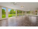 Sunroom with tiled floors and large windows offering a view of the landscaped backyard at 19053 N Lakeforest Dr, Sun City, AZ 85373
