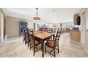 Bright dining room with a large table, seating for eight, and open kitchen at 19215 N Concho Cir, Sun City, AZ 85373