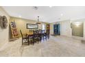 Bright dining room with a wooden table, chairs, travertine tile flooring and decorative accents at 19215 N Concho Cir, Sun City, AZ 85373