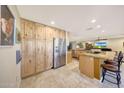 Spacious kitchen featuring ample cabinet space, stainless steel appliances, and a breakfast bar at 19215 N Concho Cir, Sun City, AZ 85373