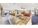 Open-concept living area with tile flooring, ceiling fan, and comfortable seating at 19215 N Concho Cir, Sun City, AZ 85373