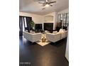 Cozy living room with two plush sofas, a fireplace, and contemporary decor at 21570 N Greenway Rd, Maricopa, AZ 85138