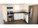 Well-appointed kitchen with stainless steel appliances, ample cabinet space, and laminate floors at 227 N Morris --, Mesa, AZ 85201