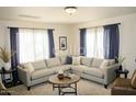 Inviting living room featuring a comfortable sectional sofa and abundant natural light from large windows at 227 N Morris --, Mesa, AZ 85201