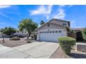 Two-story home with an attached two-car garage and desert landscaping for low maintenance at 2302 E Paraiso Dr, Phoenix, AZ 85024