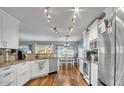 Bright, updated kitchen featuring white cabinets, stainless steel appliances and wood flooring at 2302 E Paraiso Dr, Phoenix, AZ 85024