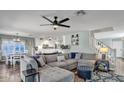 Comfortable living room space with plush seating, adjacent to an open-concept kitchen and dining area at 2302 E Paraiso Dr, Phoenix, AZ 85024