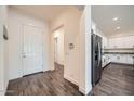 Inviting entryway with a view of the kitchen, featuring wood-look tile flooring and a neutral color palette at 23139 E Via Del Sol --, Queen Creek, AZ 85142