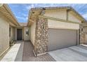 Close-up of the garage and front entryway, showcasing the stonework and neutral-colored exterior at 23139 E Via Del Sol --, Queen Creek, AZ 85142