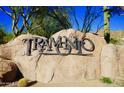 Stone Tramonto community sign surrounded by desert landscaping and a vibrant blue sky backdrop at 3038 W Trapanotto Rd, Phoenix, AZ 85086