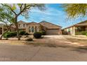 Inviting single-story home with a well-manicured front yard and a spacious two-car garage at 3038 W Trapanotto Rd, Phoenix, AZ 85086