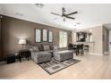 This inviting living room boasts modern ceiling fan, stylish neutral walls, and blends seamlessly into the eat-in kitchen at 3241 E Hampton Ln, Gilbert, AZ 85295