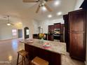 Bright, open kitchen featuring a granite island, and a full view into the open concept living areas at 3284 E Sandy Way, Gilbert, AZ 85297