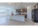 Open-concept kitchen with an island, stainless steel appliances, and a seamless flow to the living area at 4150 S Neutron --, Mesa, AZ 85212