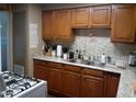 Functional kitchen features wood cabinets, laminate countertops, and stainless steel double sink at 4223 E Earll Dr, Phoenix, AZ 85018