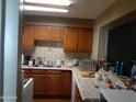 A clean kitchen features wood cabinets, stainless steel appliances, and laminate countertops at 4223 E Earll Dr, Phoenix, AZ 85018