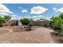 Serene backyard featuring a paver patio, gravel landscaping, and a storage shed, perfect for outdoor enjoyment at 4321 E Rowel Rd, Phoenix, AZ 85050