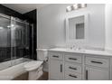 Charming bathroom with vanity, framed mirror, and a shower-tub combination with glass doors at 4321 E Rowel Rd, Phoenix, AZ 85050