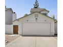 Attached two-car garage with desert landscaping and gated side entry at 440 N New Hvn, Mesa, AZ 85205