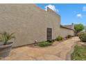 Desert home's private flagstone patio, accentuated by potted plants and lush landscaping at 4545 E Wescott Dr, Phoenix, AZ 85050