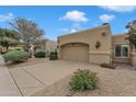 Desert home showcasing a two-car garage and low-maintenance landscape, set against a clear blue sky at 4545 E Wescott Dr, Phoenix, AZ 85050