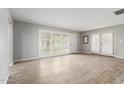 Bright living room showcasing wood-look floors, plantation shutters, and neutral paint scheme at 523 W 14Th St, Tempe, AZ 85281