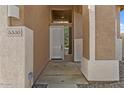 Inviting home entrance with a modern door, desert landscaping and stacked stone columns at 5330 W Morgan Pl, Chandler, AZ 85226