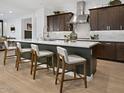 Modern kitchen with white countertops, stainless steel appliances, and island with seating at 5457 S Benton --, Mesa, AZ 85212