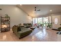 Bright living room with vaulted ceiling, neutral paint, tile floors, and large windows at 5831 W Saragosa St, Chandler, AZ 85226