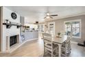 Open-concept dining area with fireplace, views of the kitchen and backyard access at 6938 W Wescott Dr, Glendale, AZ 85308