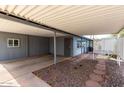 A covered patio area with a unique stone path. Perfect for entertaining or relaxing outdoors at 7302 E Baseline Rd, Mesa, AZ 85209